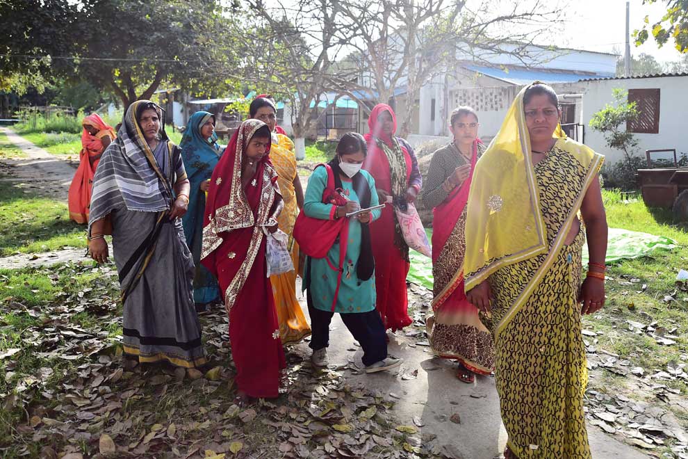 Meera Devi (centre), managing editor and reporter of Khabar Lahariya (Waves of News), speaks to village women while reporting in Banda district, Uttar Pradesh state on March 11. AFP