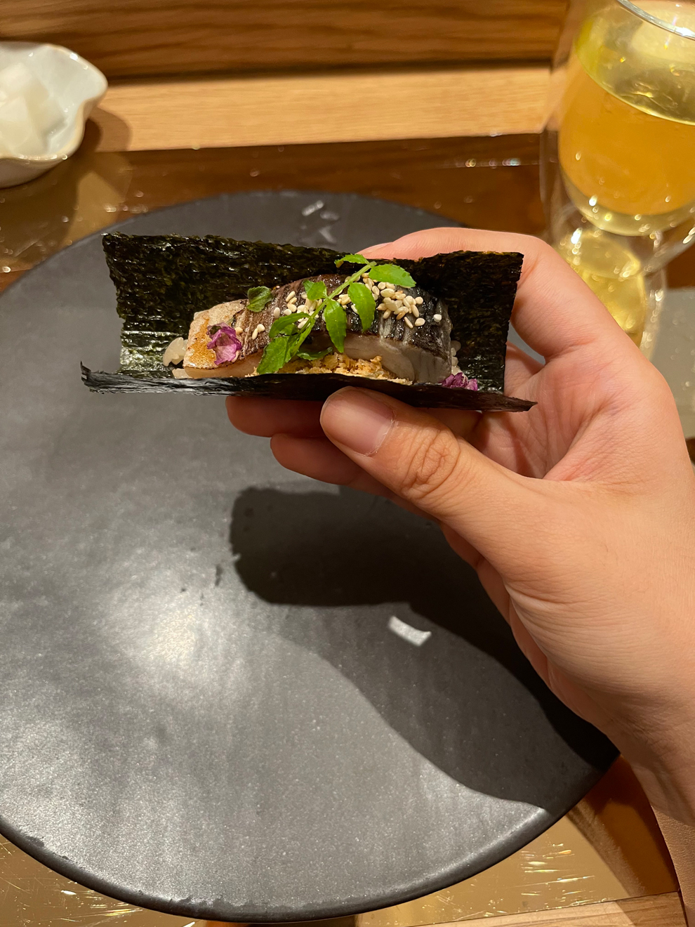 A mackerel sashimi roll prepared by the chef, handed to the reporter. Ashley Hui Yin Tan