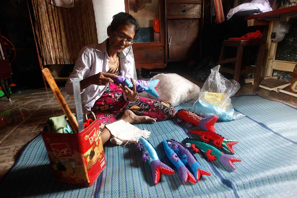 Sok Nhei, 56, fills an order for plush crocodiles at home on April 20.