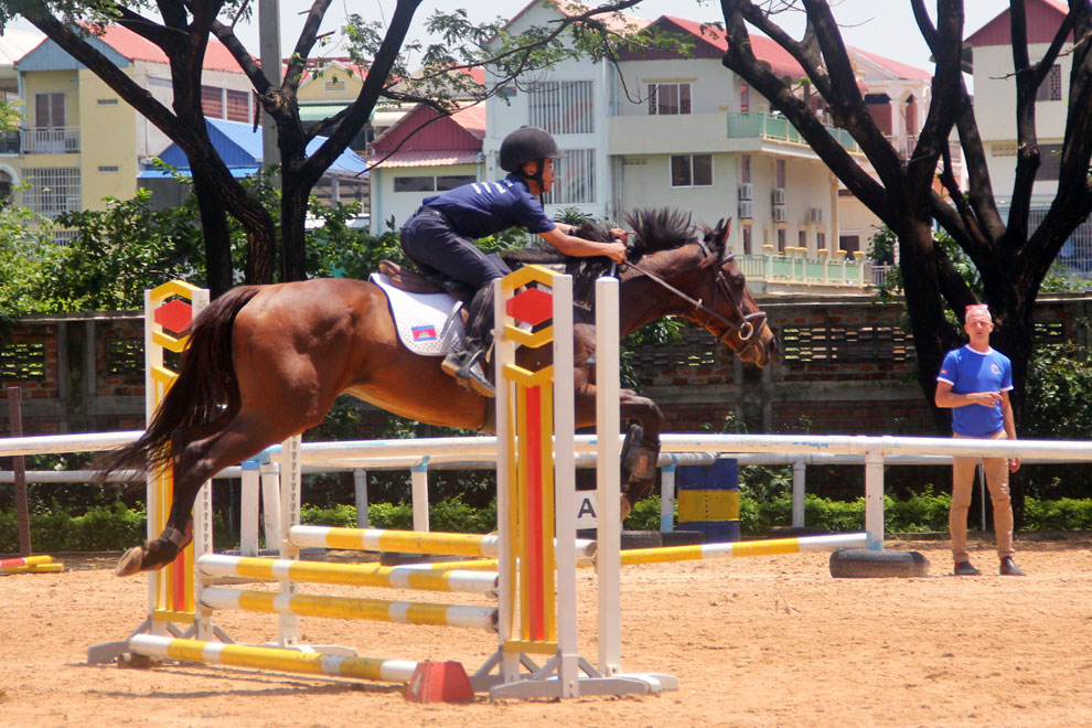 An equestrian rider clears bars at Cambodian Country Club in Phnom Penh on June 12. CHHORN NORN
