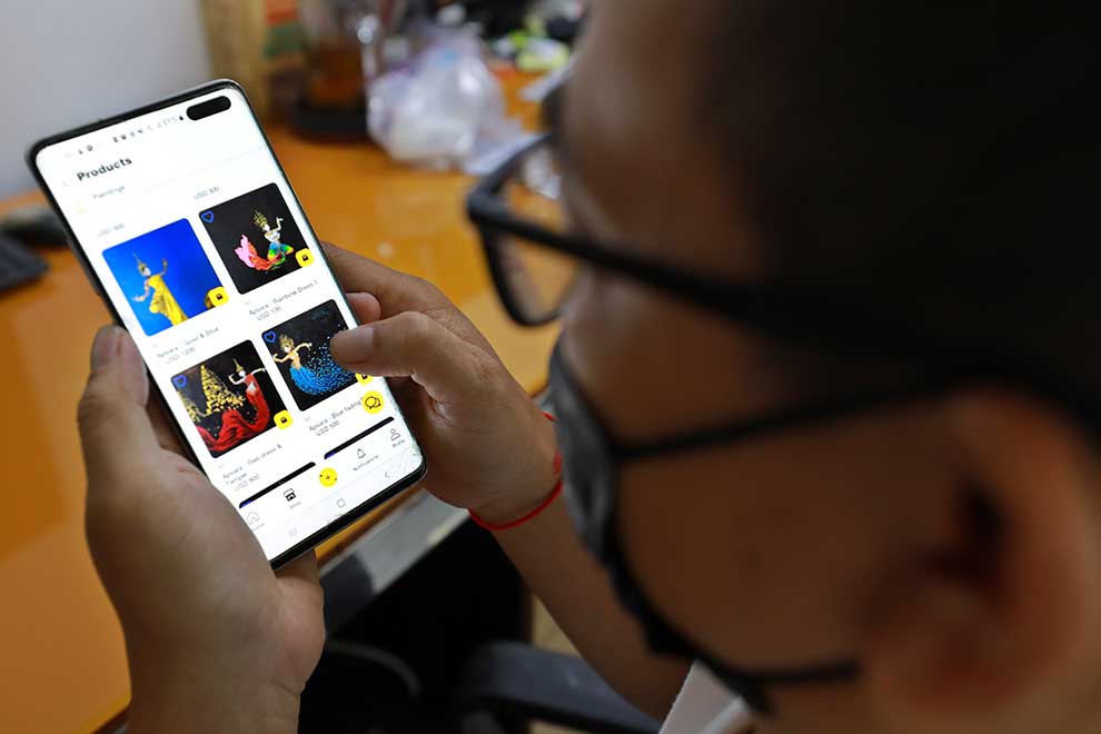 A man checks out artwork for sale via the app on June 15.