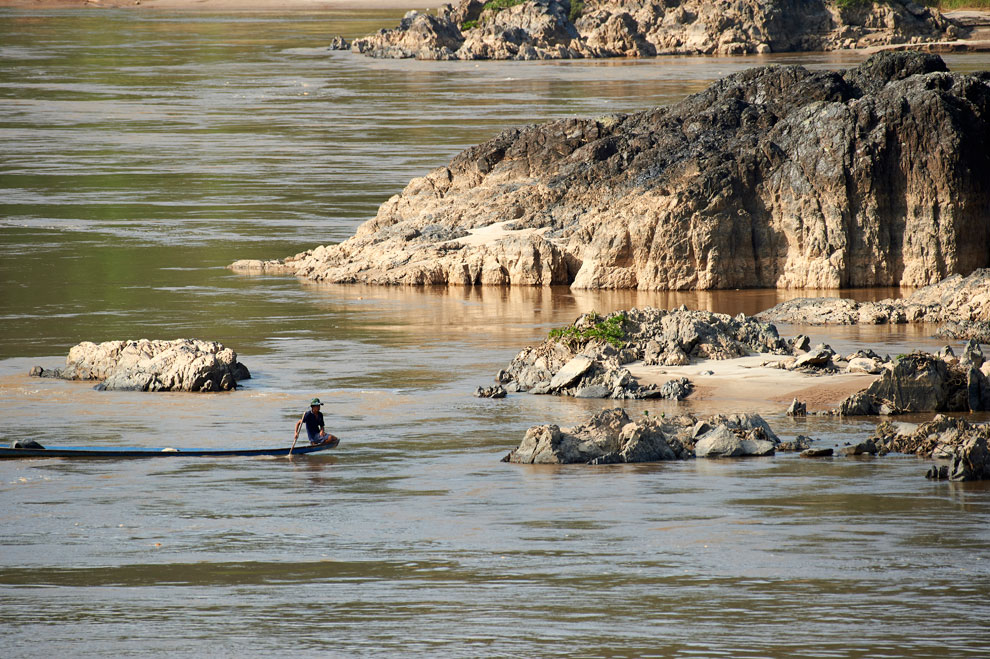 A man paddles a canoe across the Mekong River in Chiang Khong district of Northern Thailand's Chiang Rai province in November last year. MRC