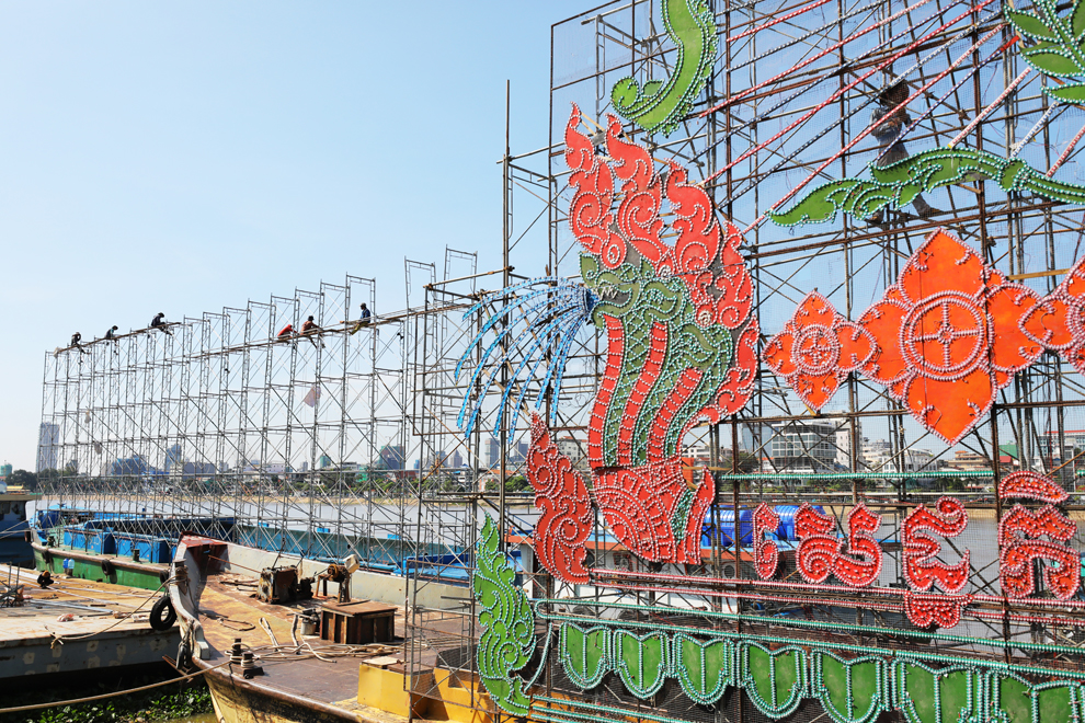 Workers install illuminated displays on barges in Chroy Changvar district on October 30. The barges will light up the river during the upcoming Water Festival.