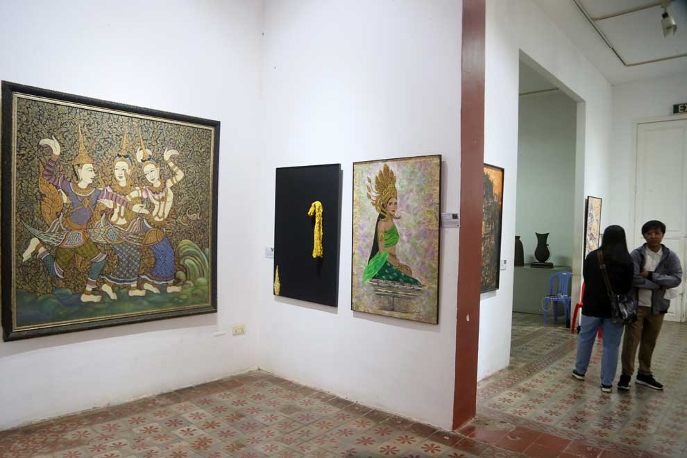 Patrons view the Apsara art exhibition at the museum.