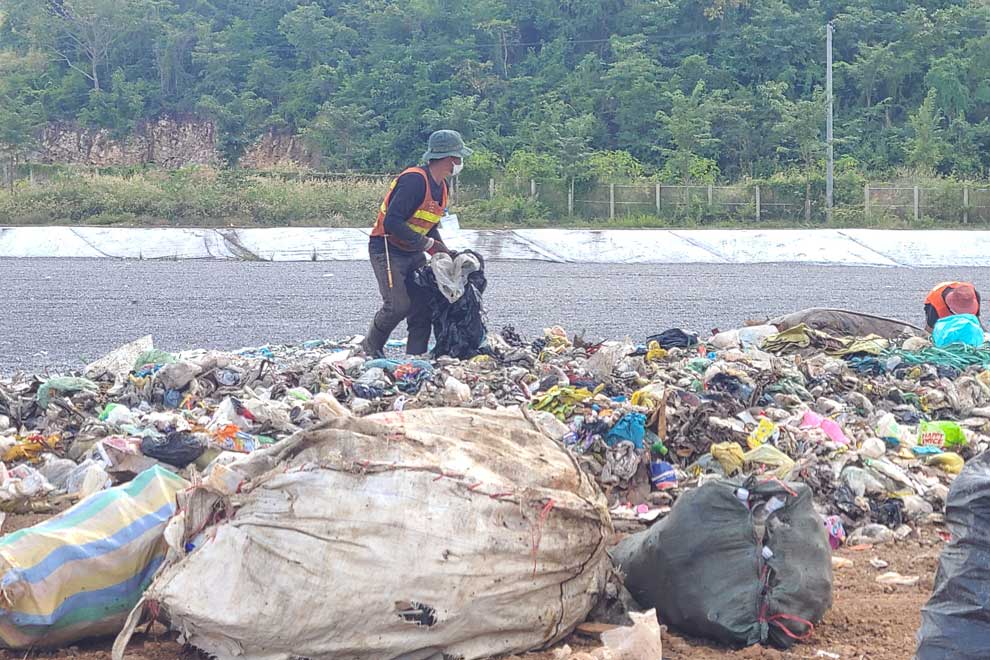 Material recovery workers sort plastic at the new landfill in Battambang province on December 9.