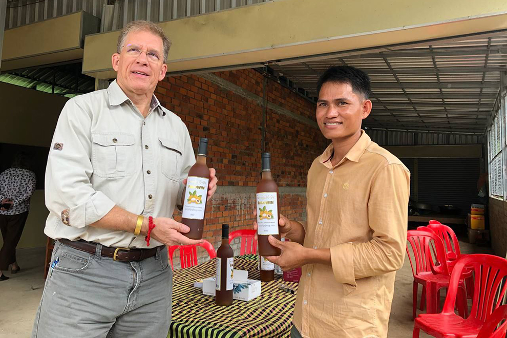 Pailin longan wine produced by Vouch Thuch, seen here with US ambassador W Patrick Murphy. Supplied