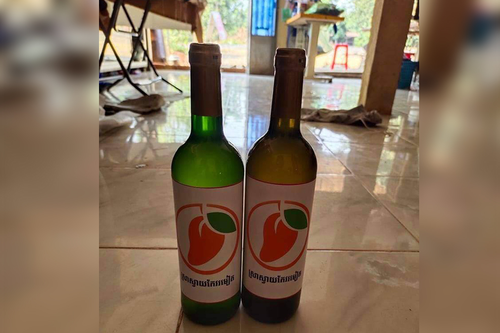 Two bottles of the delicious mango wine, produced in Pailin province. Supplied