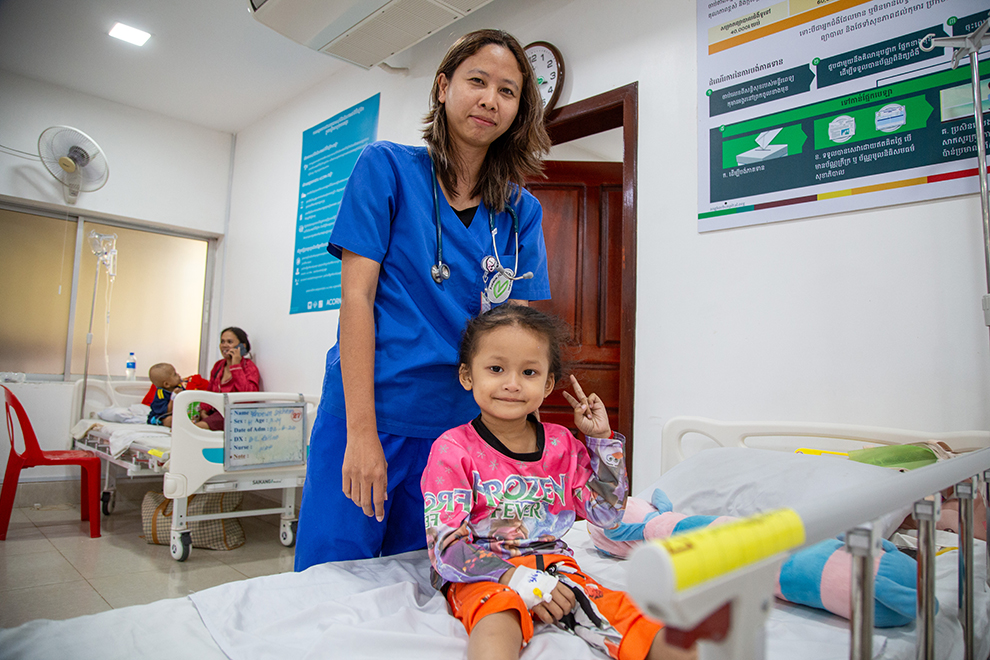 A young patient offers a peace sign to the camera after receiving treatment at the Angkor Hospital for Children (AHC). Since its inception, the hospital has provided free treatment to more than 2.5 million Cambodian Children. Supplied