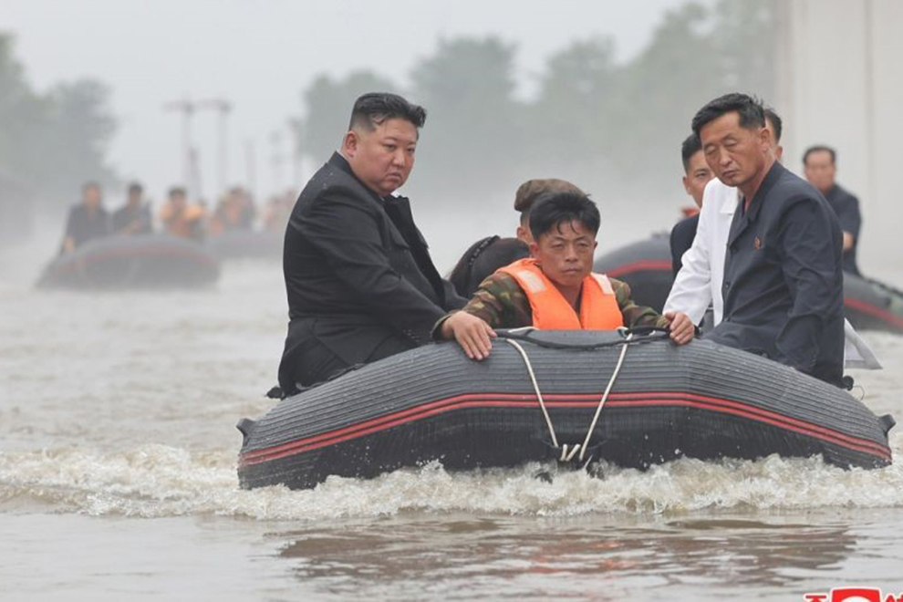 North Korean leader Kim Jong Un (left) inspects flood-hit areas in Sinuiju, North Pyongan Province, in this undated photo provided by the North's official Korean Central News Agency. ANN