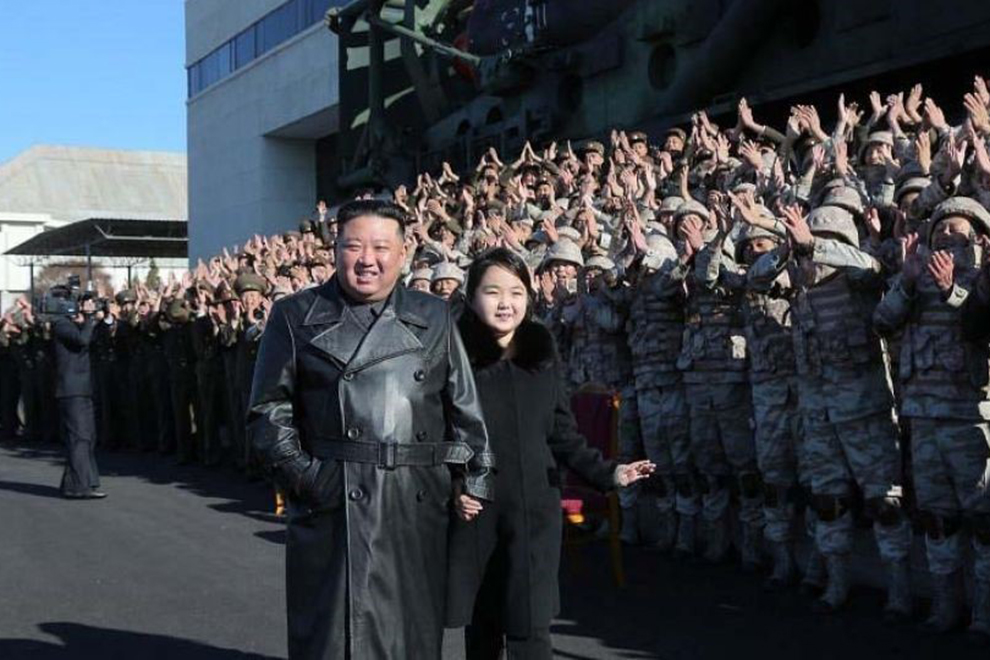 North Korean leader Kim Jun Un and his daughter Kim Ju Ae (right) review troops at a recent parade in Pyongyang, North Korea. ANN