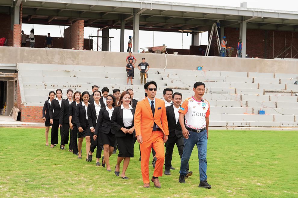 Akihiro Kato (in sunglasses), president of Angkor Tigers FC, leads his team members on an inspection tour of the club’s new stadium on September 17. Angkor Tiger
