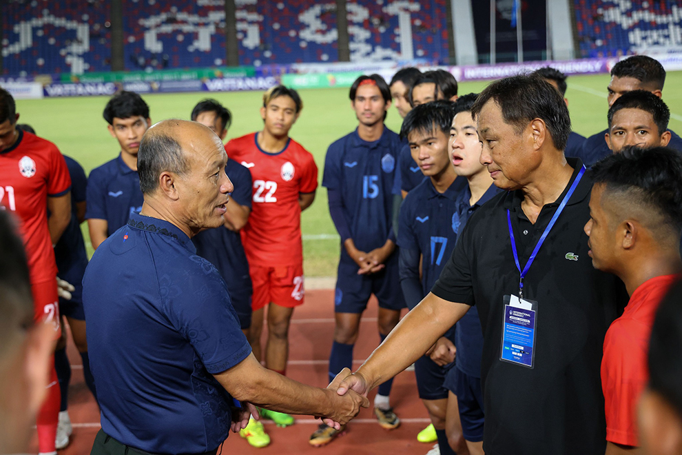 Sao Sokha (left), president of the Football Federation of Cambodia (FFC), shakes hands with Koji Gyotoku after the Japanese coach led the Kouprey to a 3-2 victory over Chinese Taipei on October 11. FFC