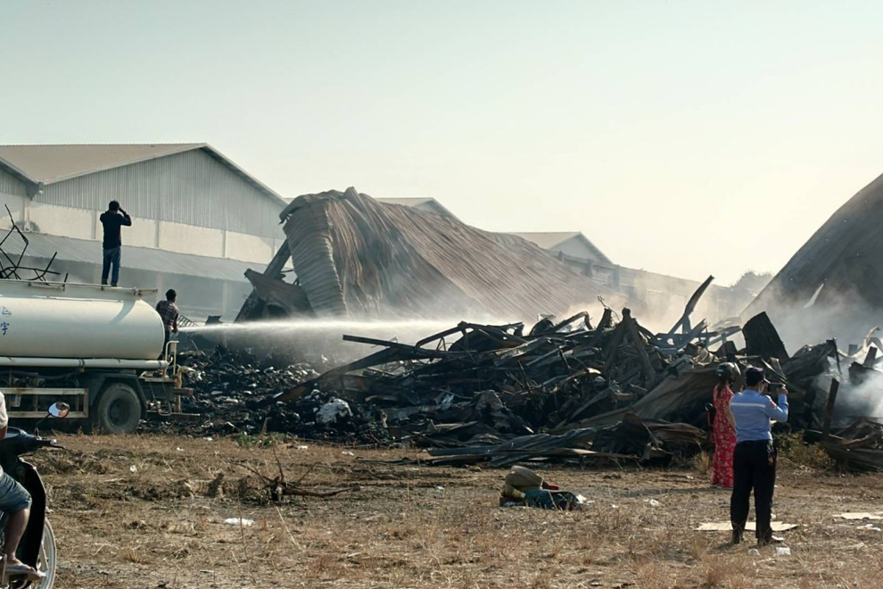 Firemen continue to dampen the smouldering remains of the factory the following morning. CENTRAL