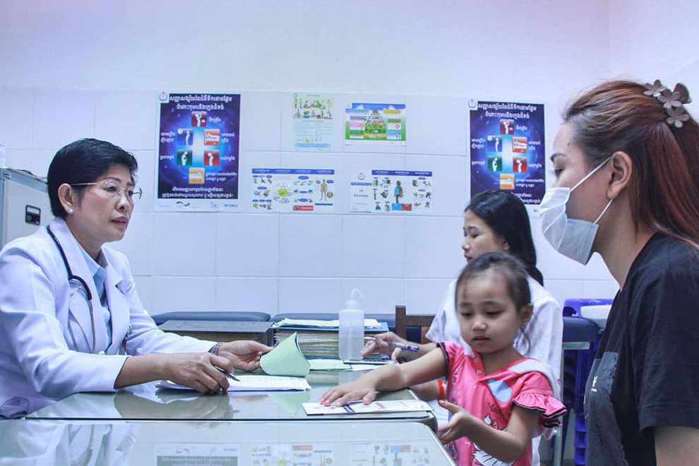 Iv Malene, deputy director of Kantha Bopha Children’s Hospital in Phnom Penh, consults with a family. Supplied