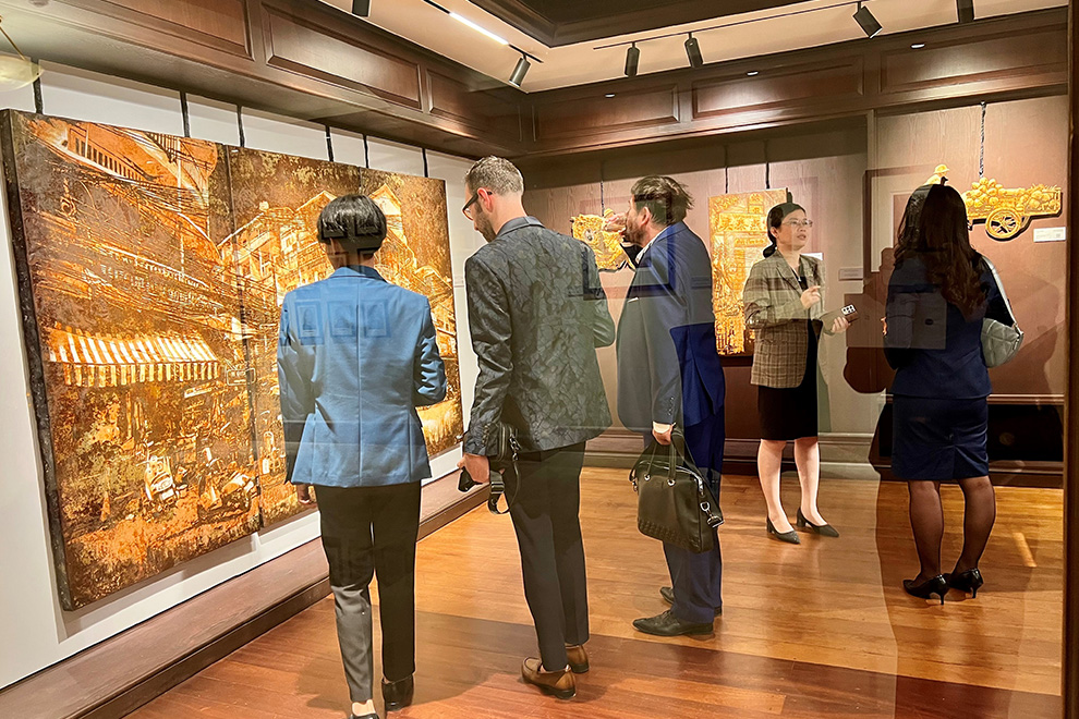 Impressed guests pore over the details of the artwork at Théo Vallier's "Rust ‘n’ Streets" exhibition. Post staff