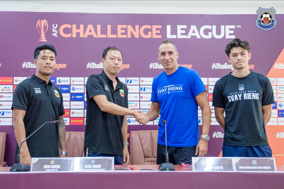 Shan United coach Ono Hiroki shakes hands with a confident Pep Munoz at a March 12 press conference. Svay Rieng FC