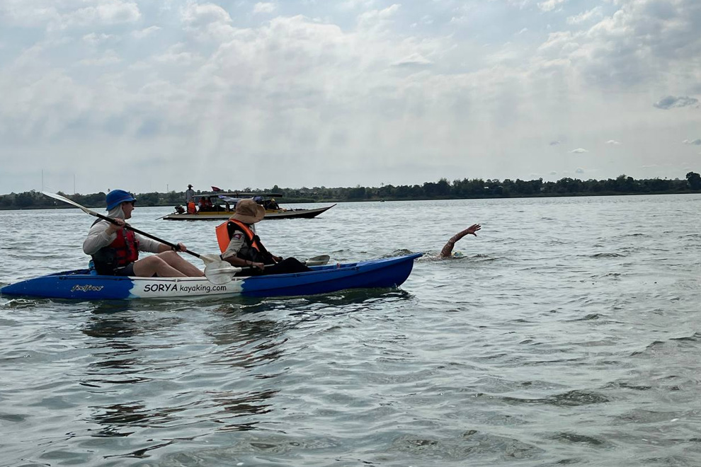 The swimmers are supported by a team in kayaks and traditional vessels. WWF Cambodia