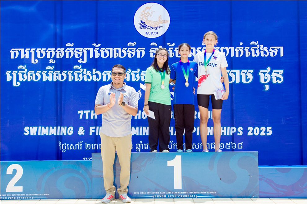 Hem Kiry, secretary-general of the Khmer Swimming Federation, presents medals to some of the winners at this year’s competition. Swimming federation