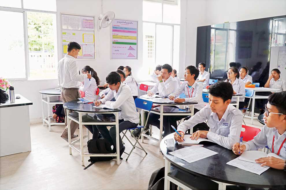 Students in class at the New Generation School on Sisowath High School’s campus in Phnom Penh. Post staffStudents of Moung Russey Secondary School in Battambang province assemble outside their new facility to sing the national anthem. Supplied