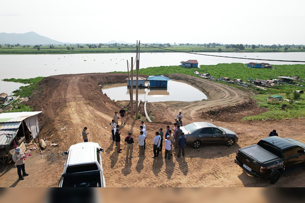 Officials inspect the site where soil was dumped into the Tonle Sap Lake to form a 70 metre dam. Tonle Sap Authority