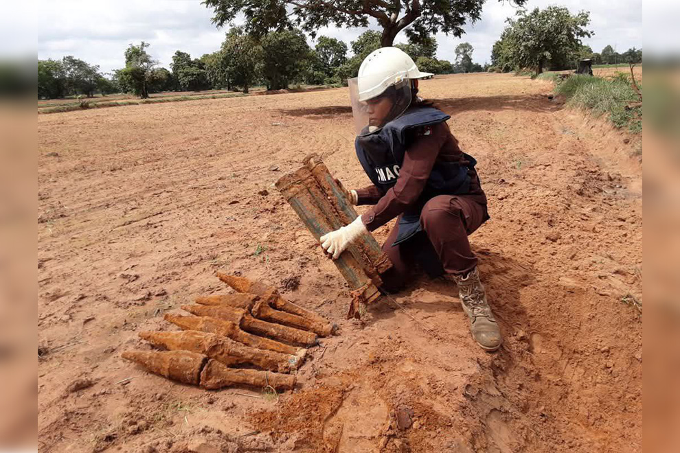 One of CMAC’s courageous deminers prepares unexploded ordnance for demolition. CMAC