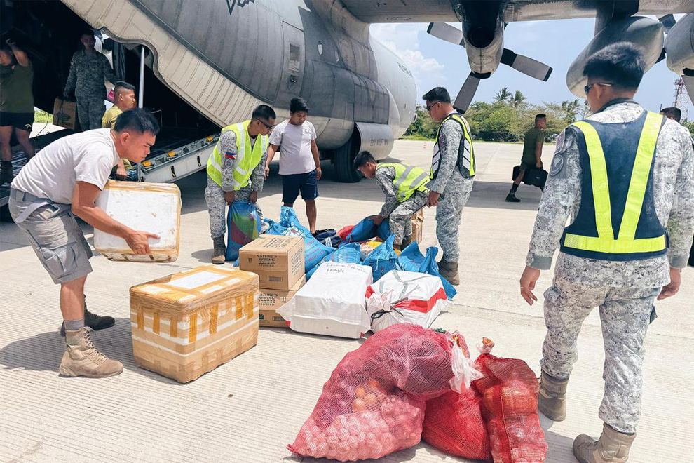 Soldiers unloading supplies for Thitu residents on June 3. PHOTO: THE STRAITS TIMES
