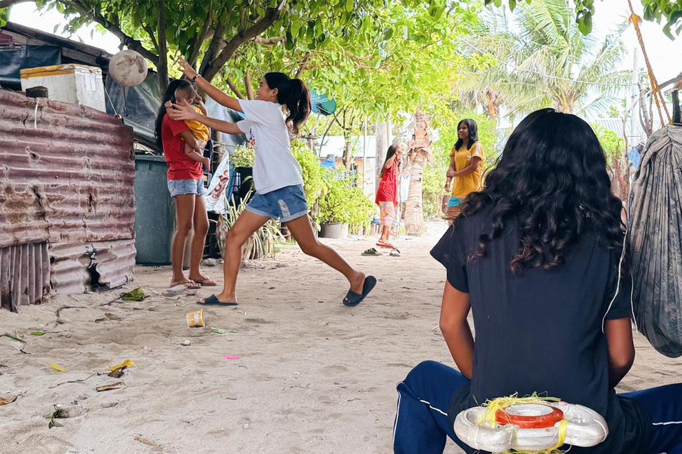 Children play dodgeball outside their homes on Thitu on June 3. PHOTO: THE STRAITS TIMES