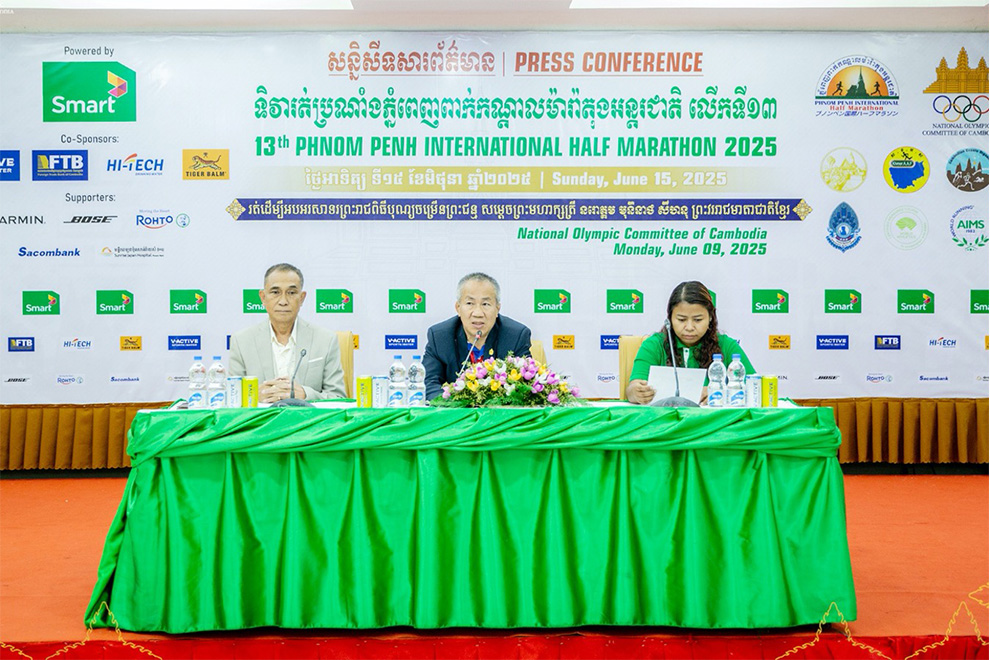 Vath Chamroeun, secretary-general of the National Olympic Committee of Cambodia (NOCC), and Sem Phalla, executive director of the marathon organising committee, attend a June 10 press conference. NOCC