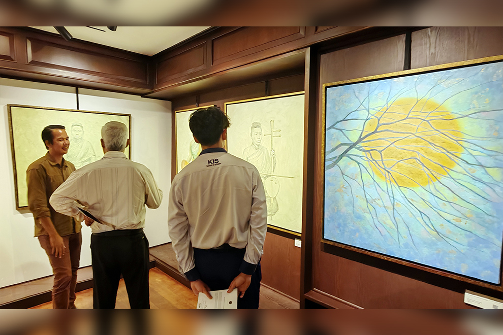 Visitors discuss the artwork, which focuses on the connection between humans and music. Hong Raksmey