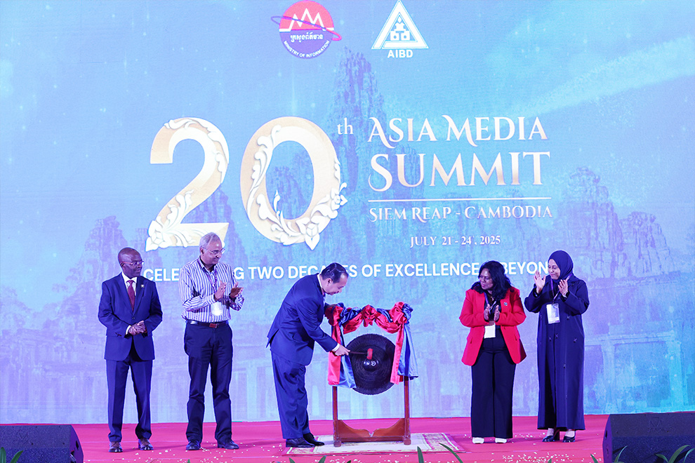 The information minister rings a gong to celebrate the opening of the summit, in Siem Reap on July 22. Supplied.