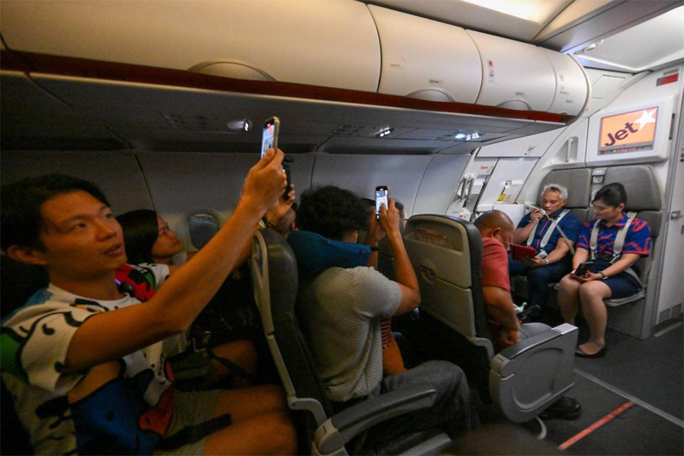 Norazman Sapiie, the in-flight customer service manager, making a speech on the last Jetstar Asia flight. PHOTO: THE STRAITS TIMES