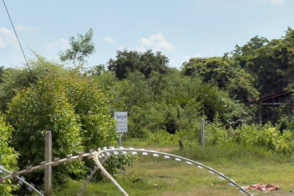 A Khmer language sign can be seen on the other side of a barbed wire barricade installed by Thai forces. Supplied