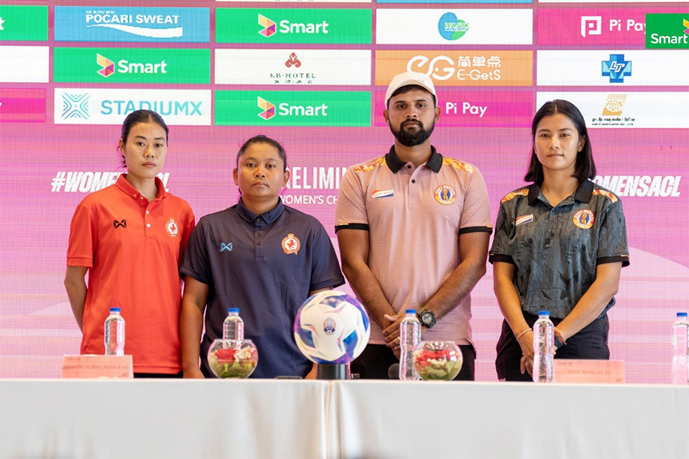 Crown captain Kim Chanthet (left) and coach Mao Savin pose for a photo with their East Bengal counterparts during an August 24 press conference. Crown