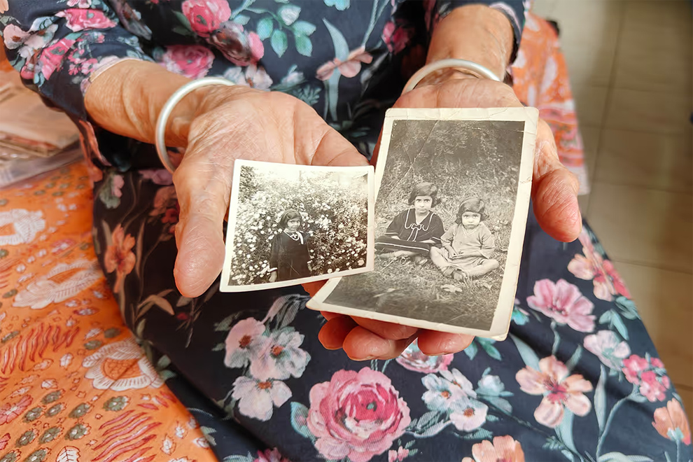 Ms Varma holding two old photos of herself and a sibling, taken during the days when their family was living in what is now Pakistan. ST PHOTO: DEBARSHI DASGUPTA