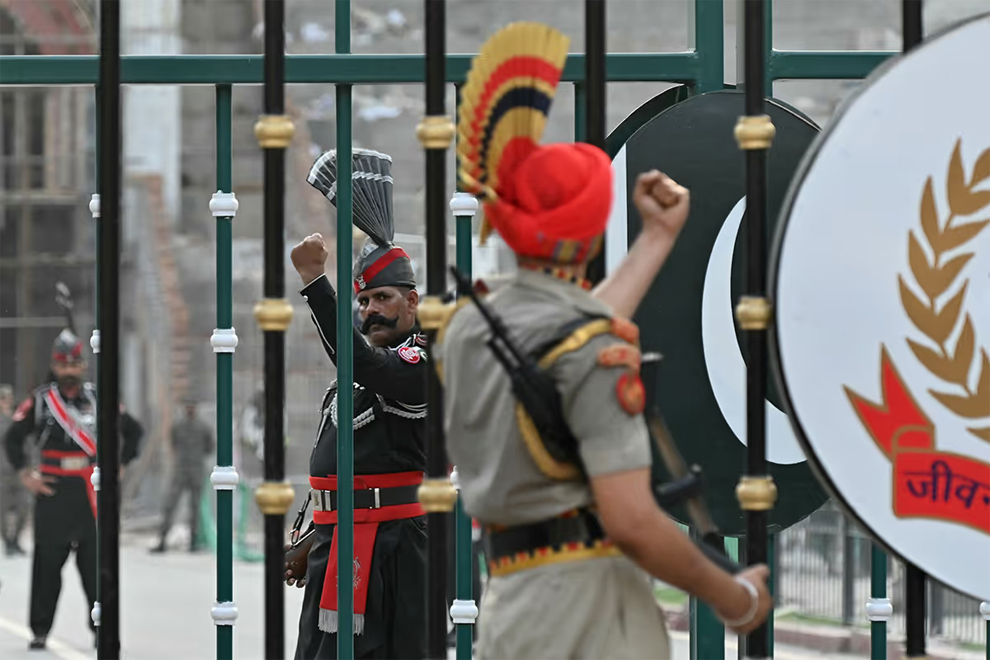 The Attari-Wagah border between Pakistan and India is heavily guarded by Pakistan Rangers (left, in black) and Indian Border Security Force personnel. PHOTO: AFP