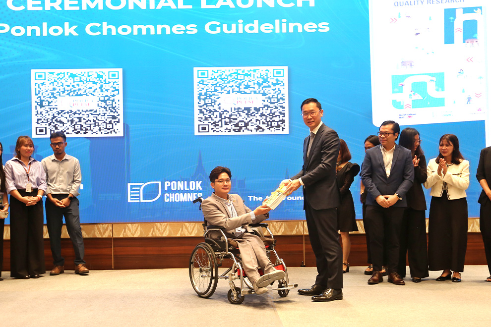 Mean Vibolvattanak (in wheelchair) handed over the two newly launched guidelines to Australian ambassador Derek Yip. Hong Raksmey