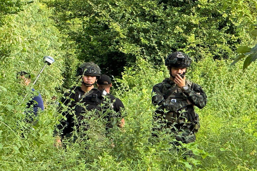 Thai soldiers escort a survey team in Banteay Meanchey province’s Chouk Chey village. Supplied