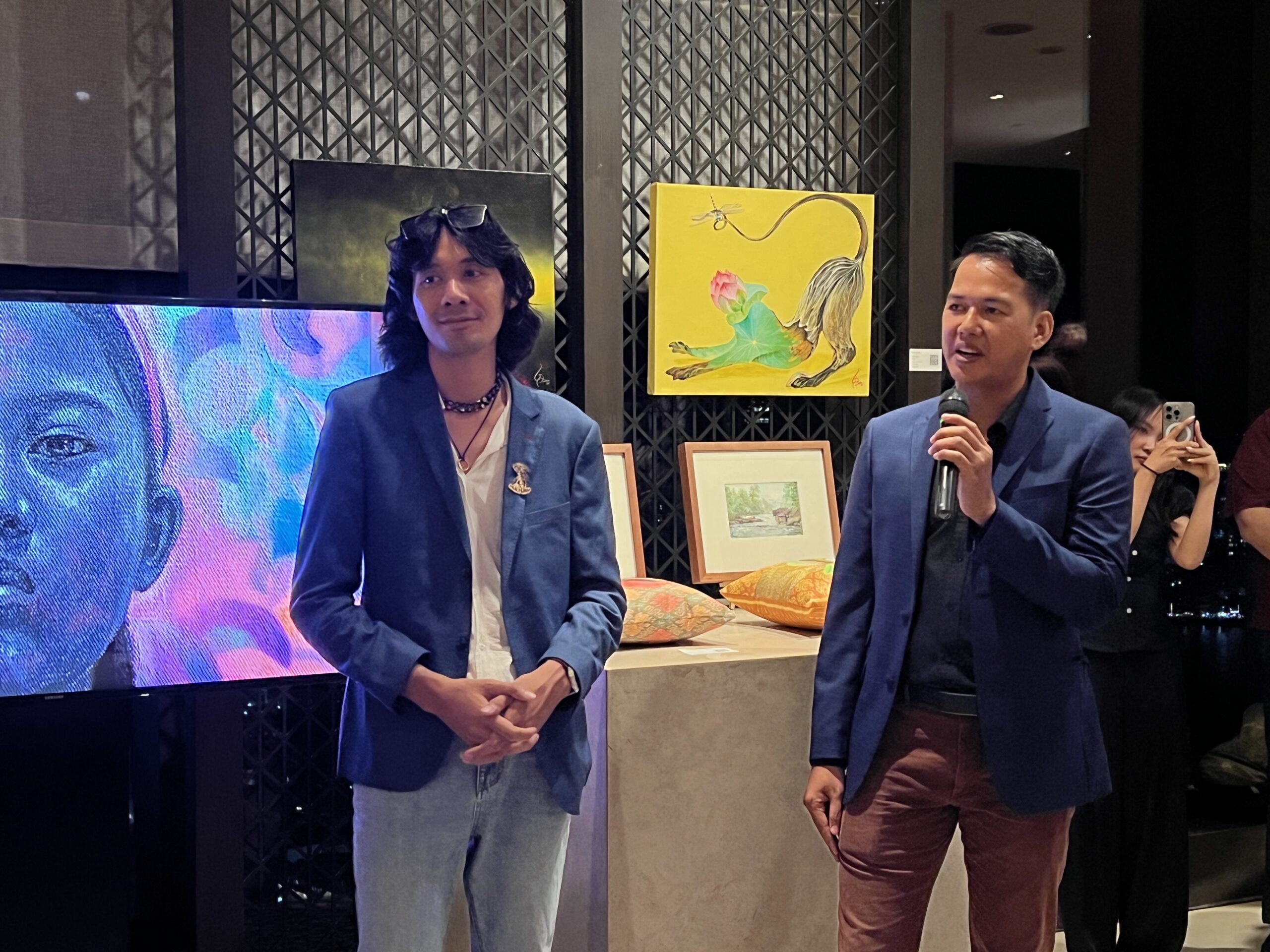 Nout Daro (left) and Thun Dina address their guests at the opening of the exhibition at Rosewood Phnom Penh. Supplied