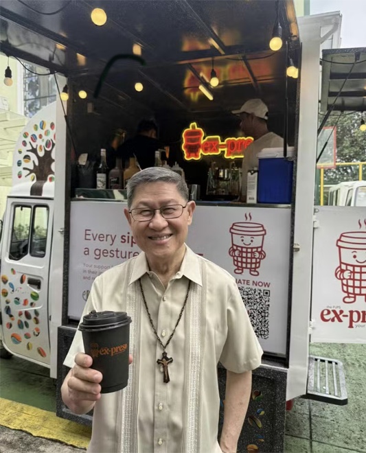 Cardinal Tagle with a cup of Ex-Preso coffee. PHOTO: CONTRIBUTED/PHILIPPINE DAILY INQUIRER