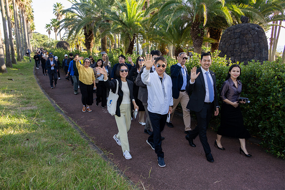 The delegates walk the 17.6-kilometre trail Olle on Jeju Island, from the Malaysia to Singapore benches. Supplied