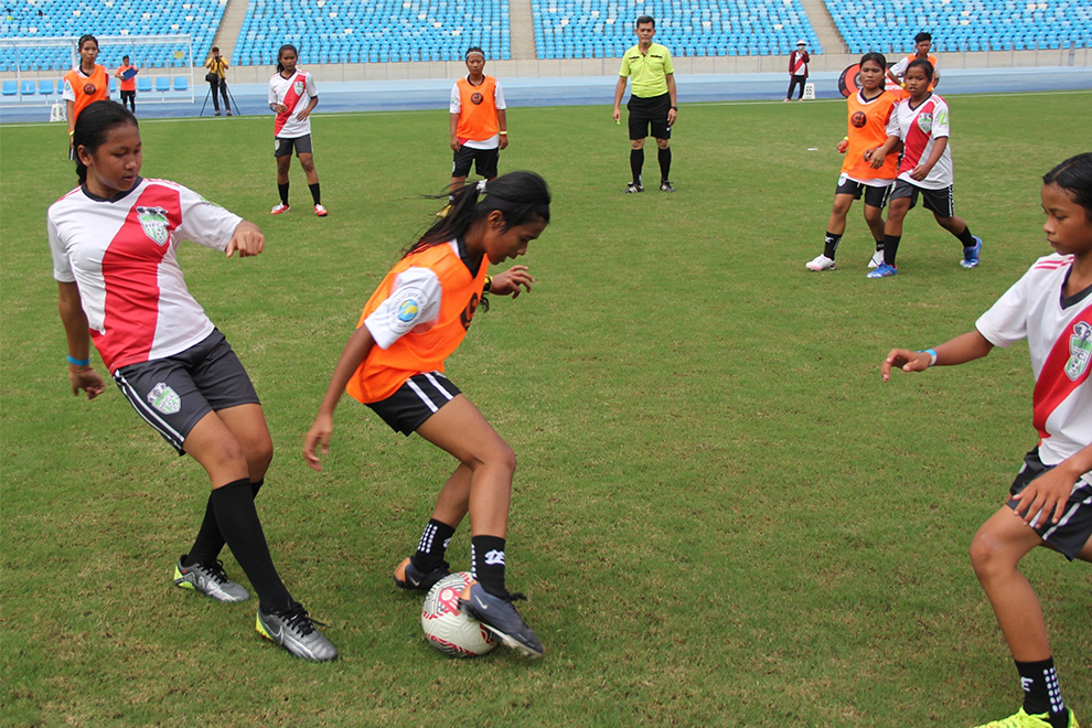 Children from Siem Reap play in the final match 0f HFCA’s 20th-anniversary celebrations at Morodok Techo National Stadium on Sunday. HFCA