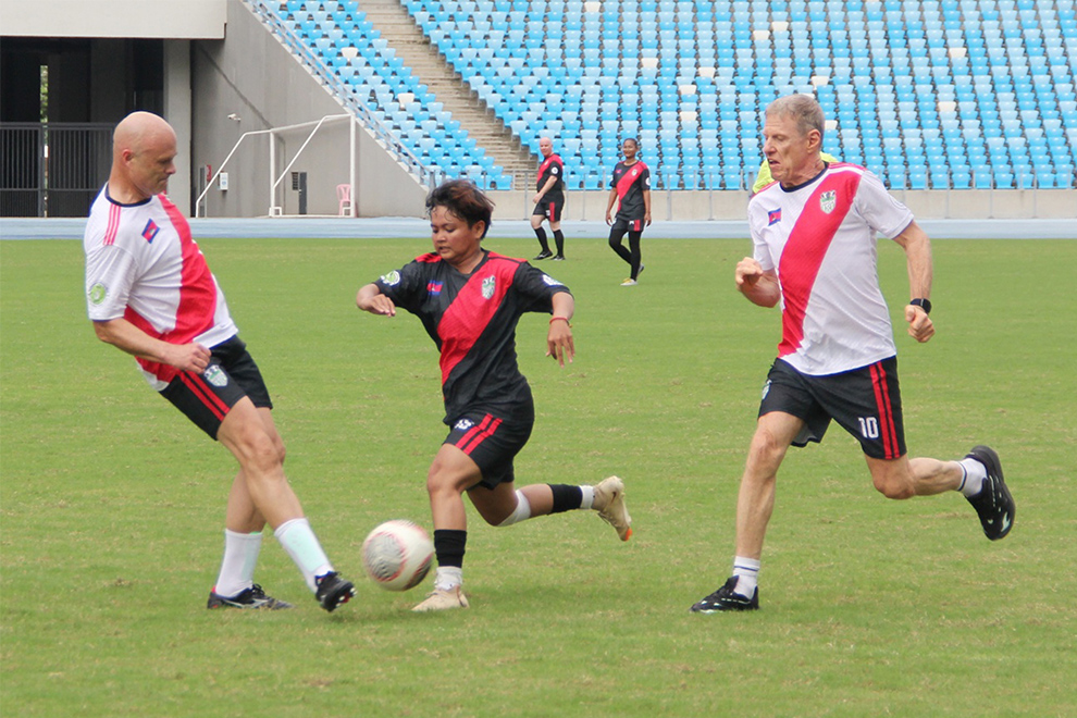 CCF founder Scott Neeson and teammates attempt to defend against their opponents during the VIP match, organised by HFCA for its 20-year anniversary. HFCA