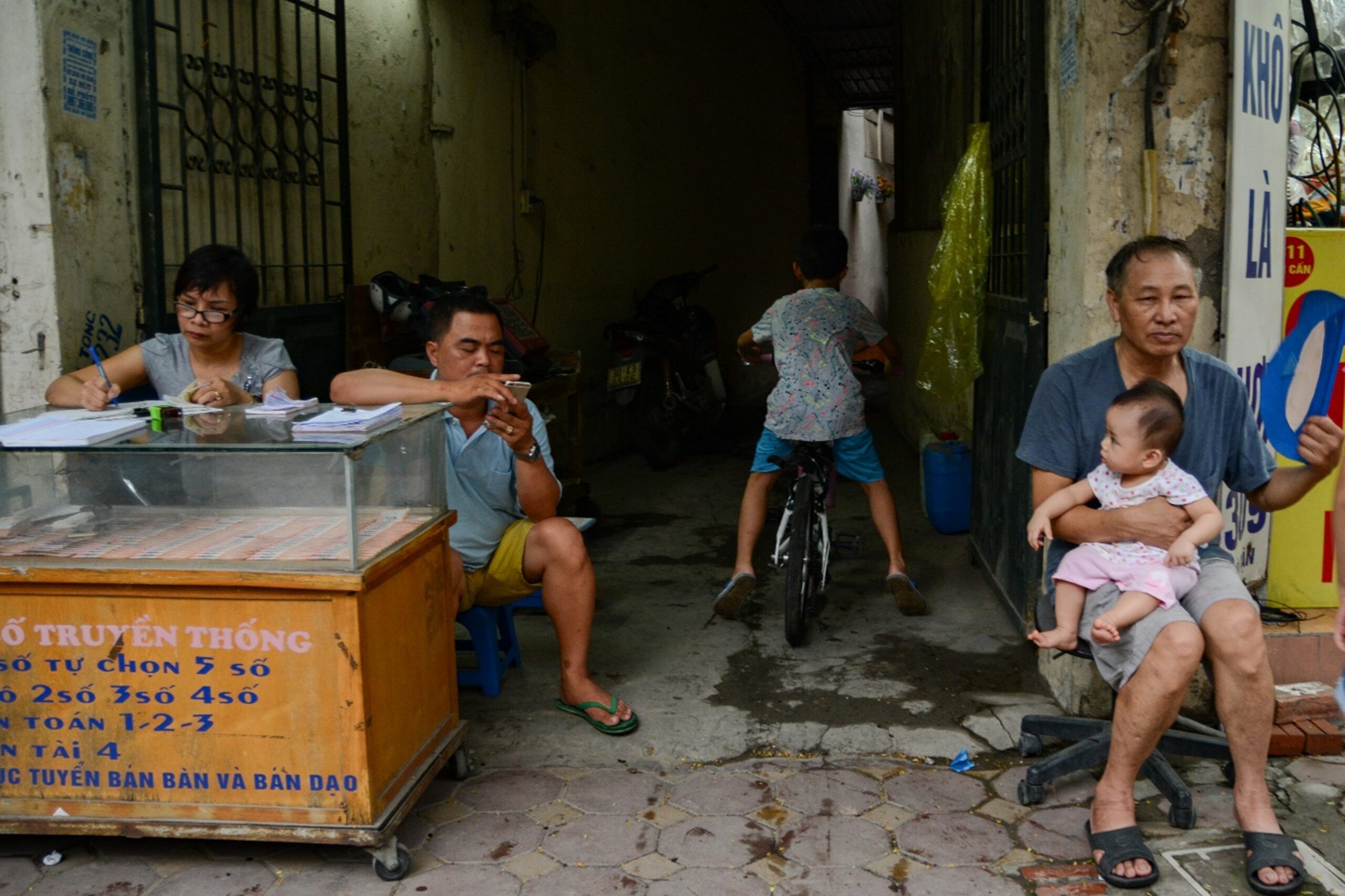 Thanh Hue, From the series In here Hanoi. People spend their time in front of a house in Hanoi, Vietnam on June 15, 2018. Supplied