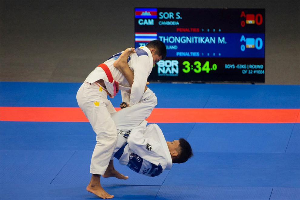A Cambodian wrestler slams his Thai opponent during a Ju-Jitsu match. JJFC