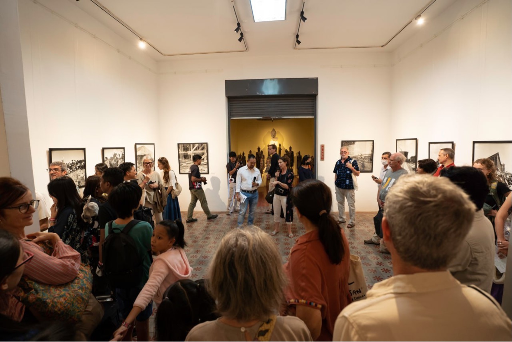 Visitors gather inside the National Museum of Cambodia for the opening of Micheline Dullin’s exhibition, featuring her 1960s photographs documenting Phnom Penh during the Prince Norodom Sihanouk era. IFC/Photo Phnom Penh