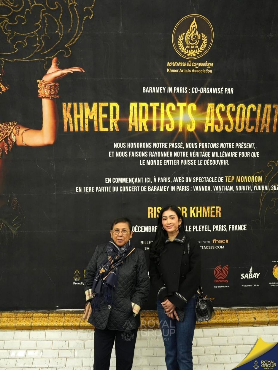 Culture minister Phoeurng Sackona (left) was one of the lucky audience members. Here, she poses for a photo in front of a poster for the event in a busy Paris metro station. Royal Group