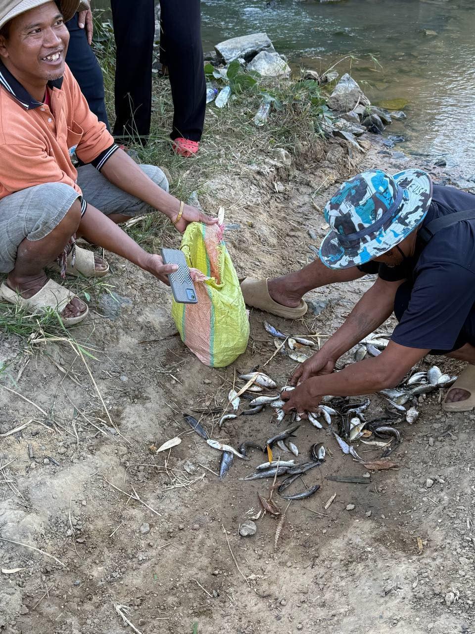 Locals collect dead fish to eat. Teuk Phos district administration