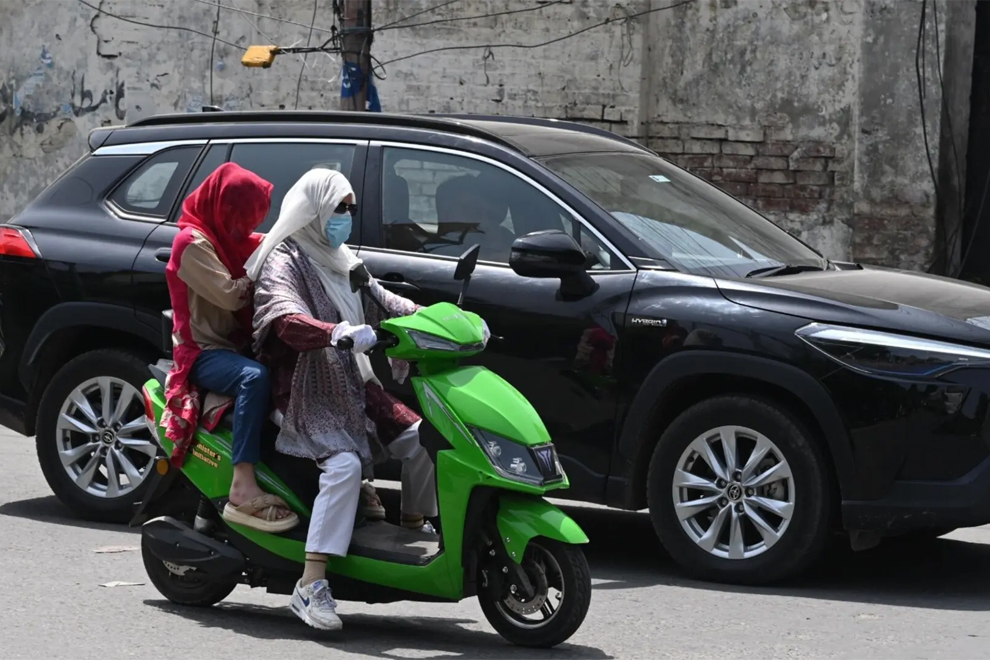Women riding their scooters on the streets of Lahore. PHOTO: WHITE STAR/DAWN
