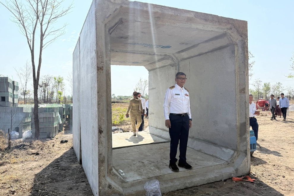 Education minister Hang Chuon Naron visits the site of a new school building and trench system at Kiriwan Senchey Primary School in Oddar Meanchey province. Supplied