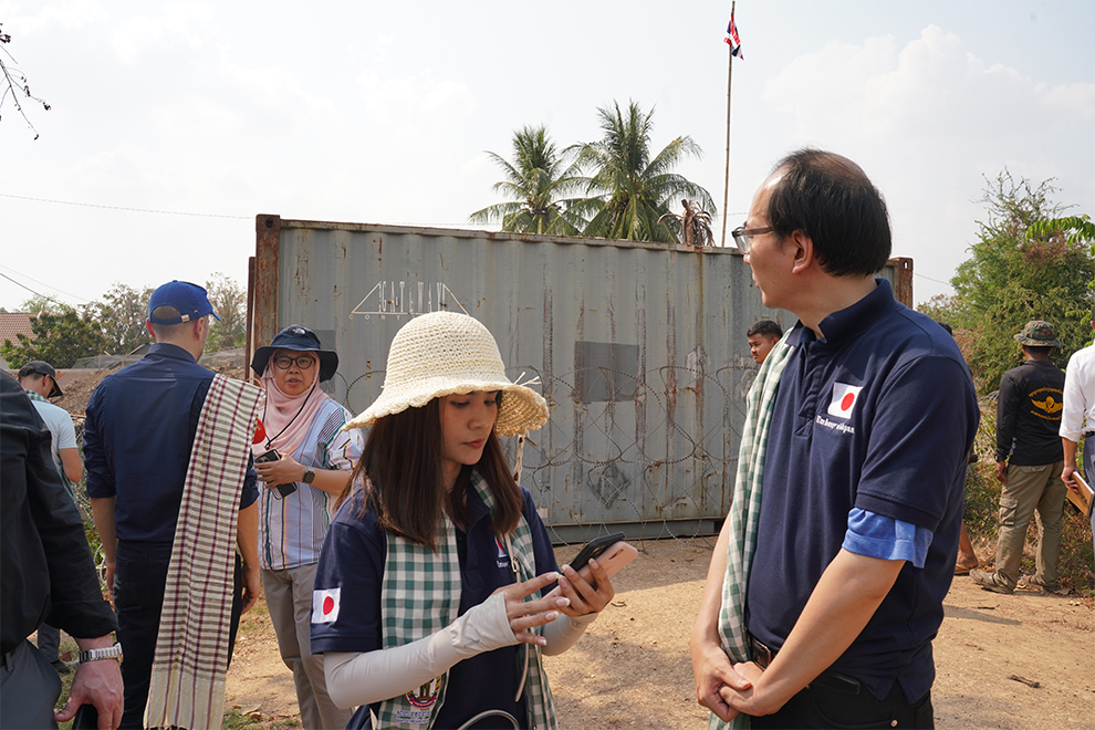 Japanese embassy councillor Matsuda Junsaku stands on Cambodian soil as he observes a shipping container with a Thai flag above it. Hong Raksmey